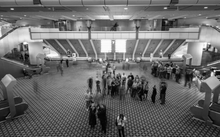 Visitors walking through the spacious atrium of a convention centre