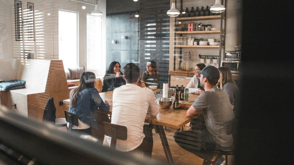 Team gathered around a table in an office kitchen